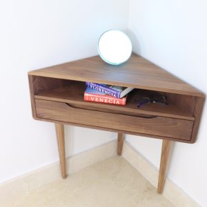 Corner nightstand with shelf and lower drawer in solid Oak or Walnut.